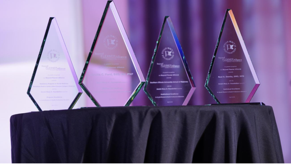Photo of four awards made out of crystal