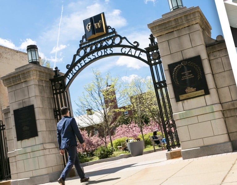 Student walking through the Professors Gate