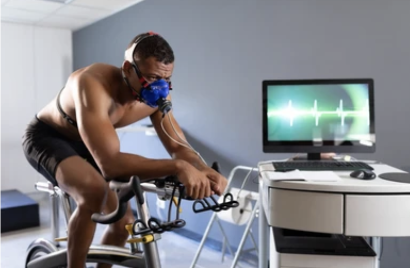Man cycling while connected to VO2 max equipment