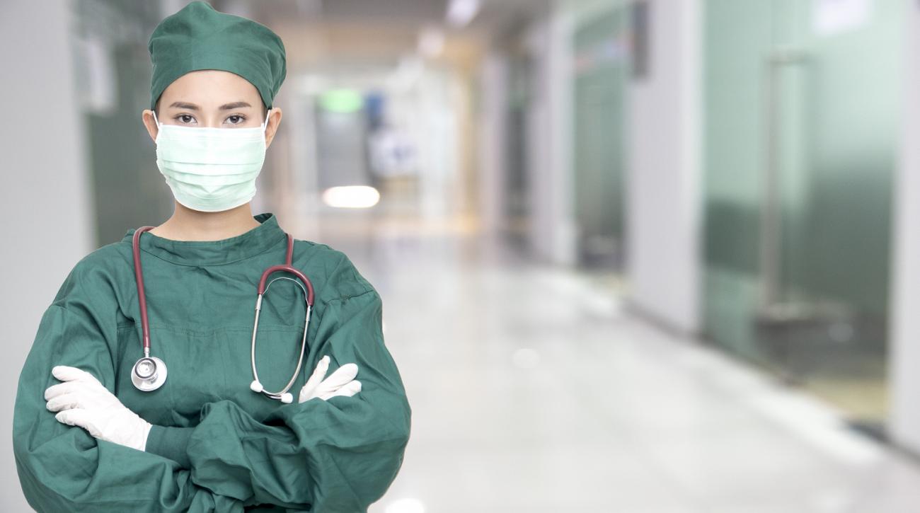 Heathcare worker looking at straight ahead wearing a mask