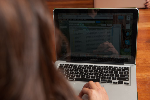 Looking at a laptop over a student's shoulder