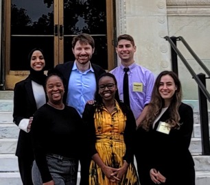 Winning team posed in front of the NASEM building