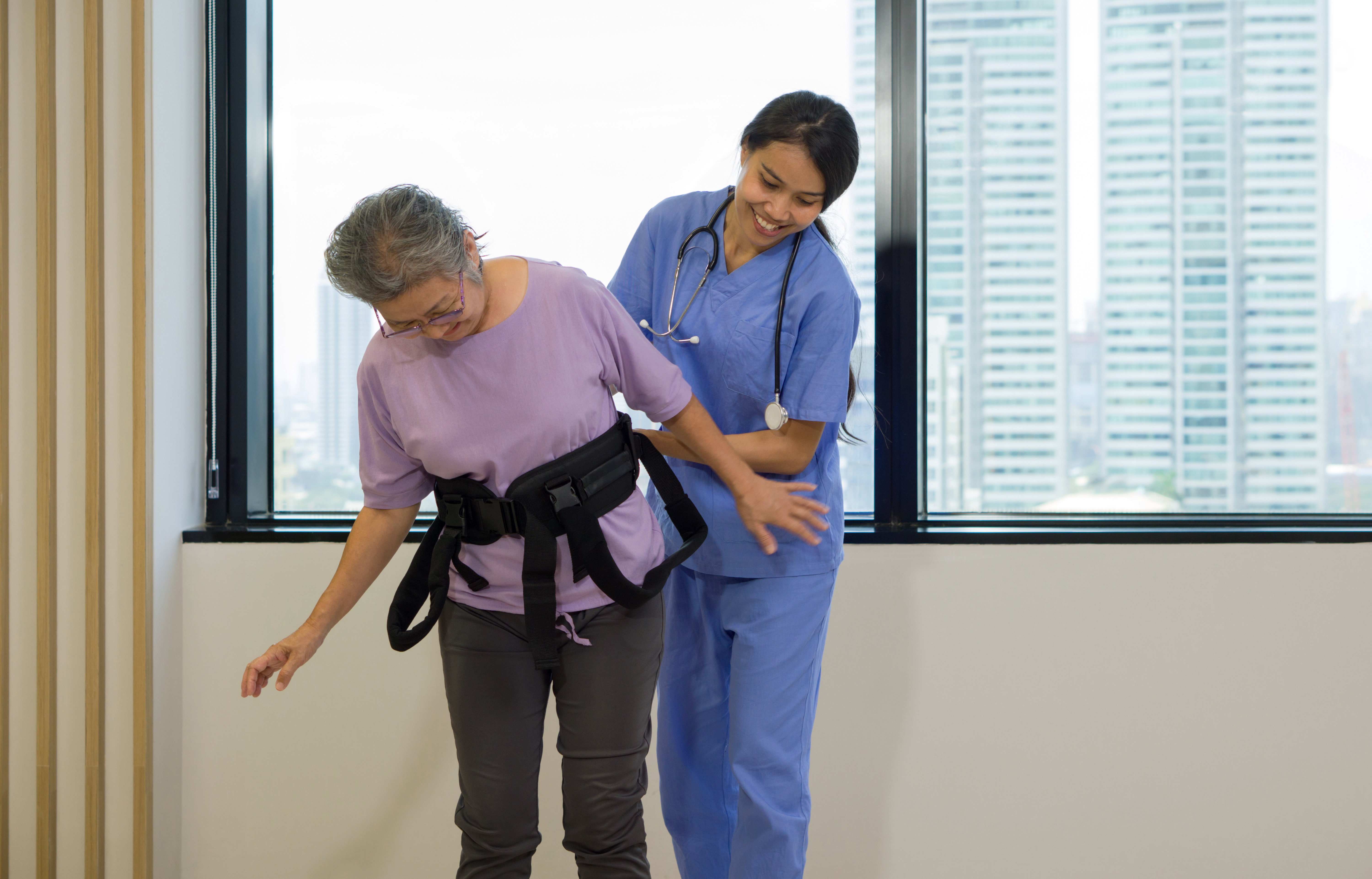 Woman working on walking with a health care worker