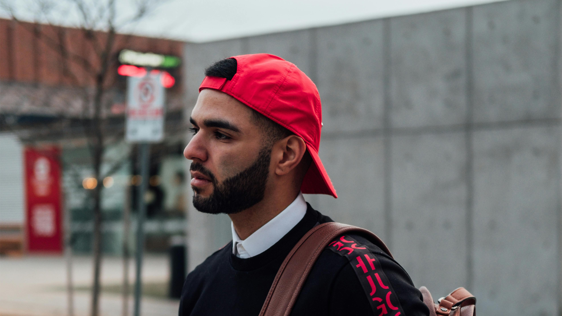 Latino man walking down a street