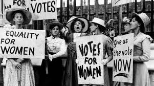 Votes for Women Black and white picture of women in the 1910's holding signs saying "Votes for Women" "Equality for Women"