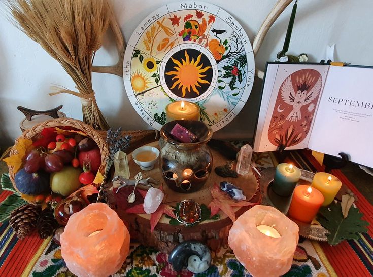 Pagan fall altar with rose quartz crystals, apples, oranges and fall fruit. Colorful candles circle the altar