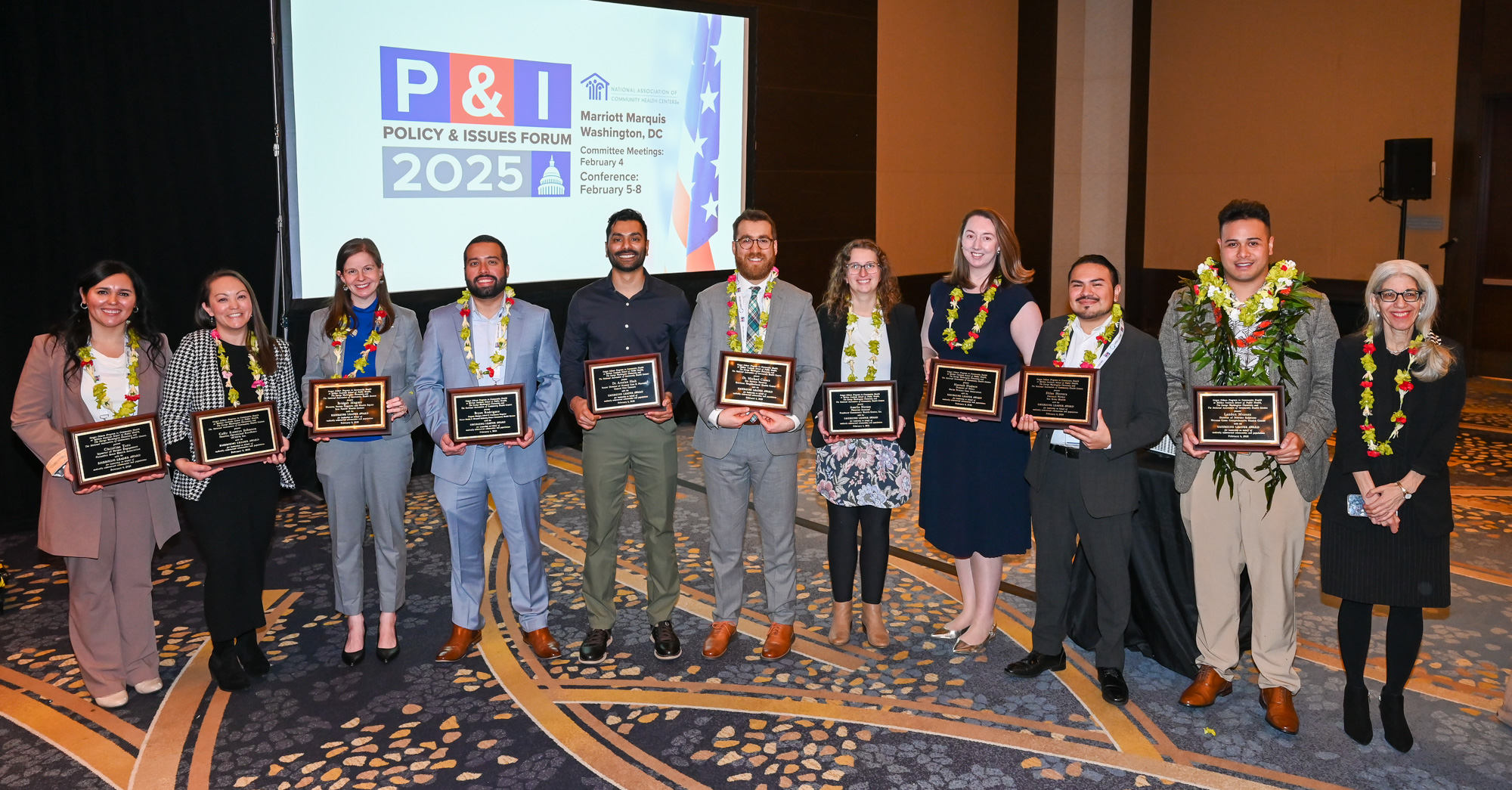 Emerging leaders holding their plaques.
