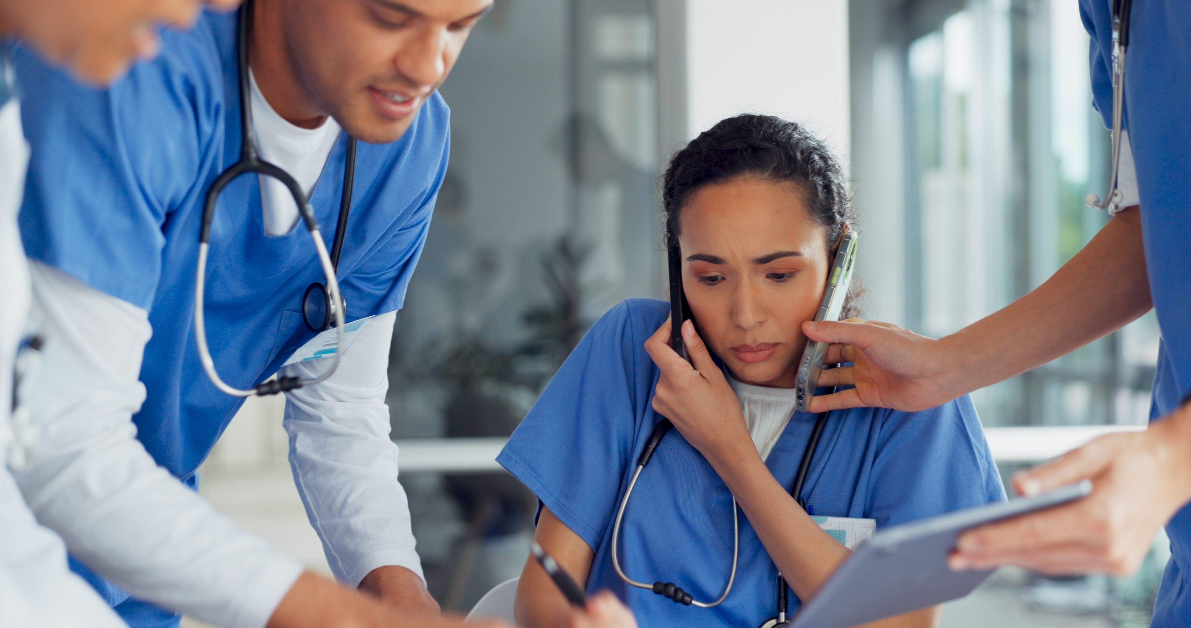 Nurse surrounded by other nurses looking very busy