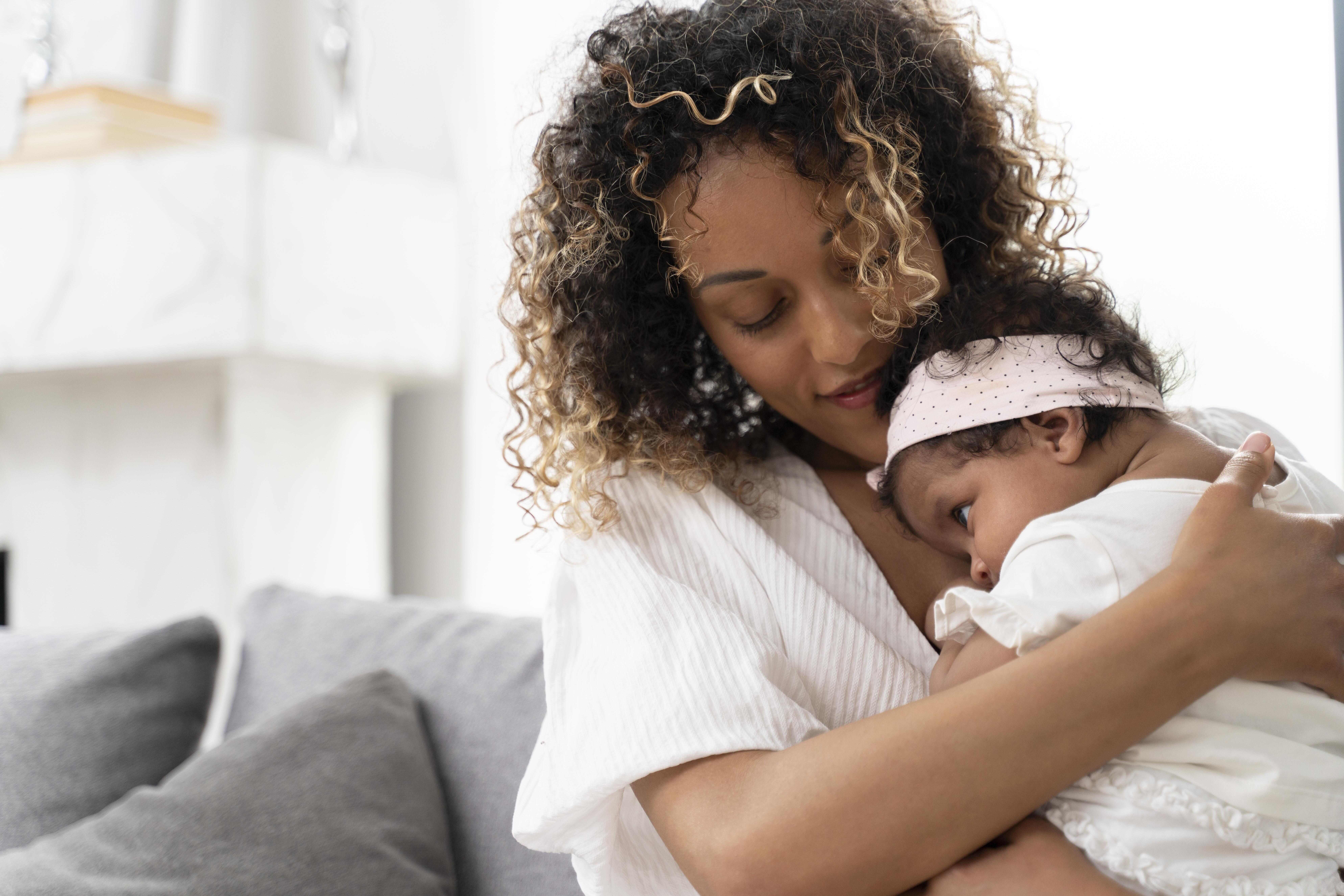 Woman holding a baby girl.