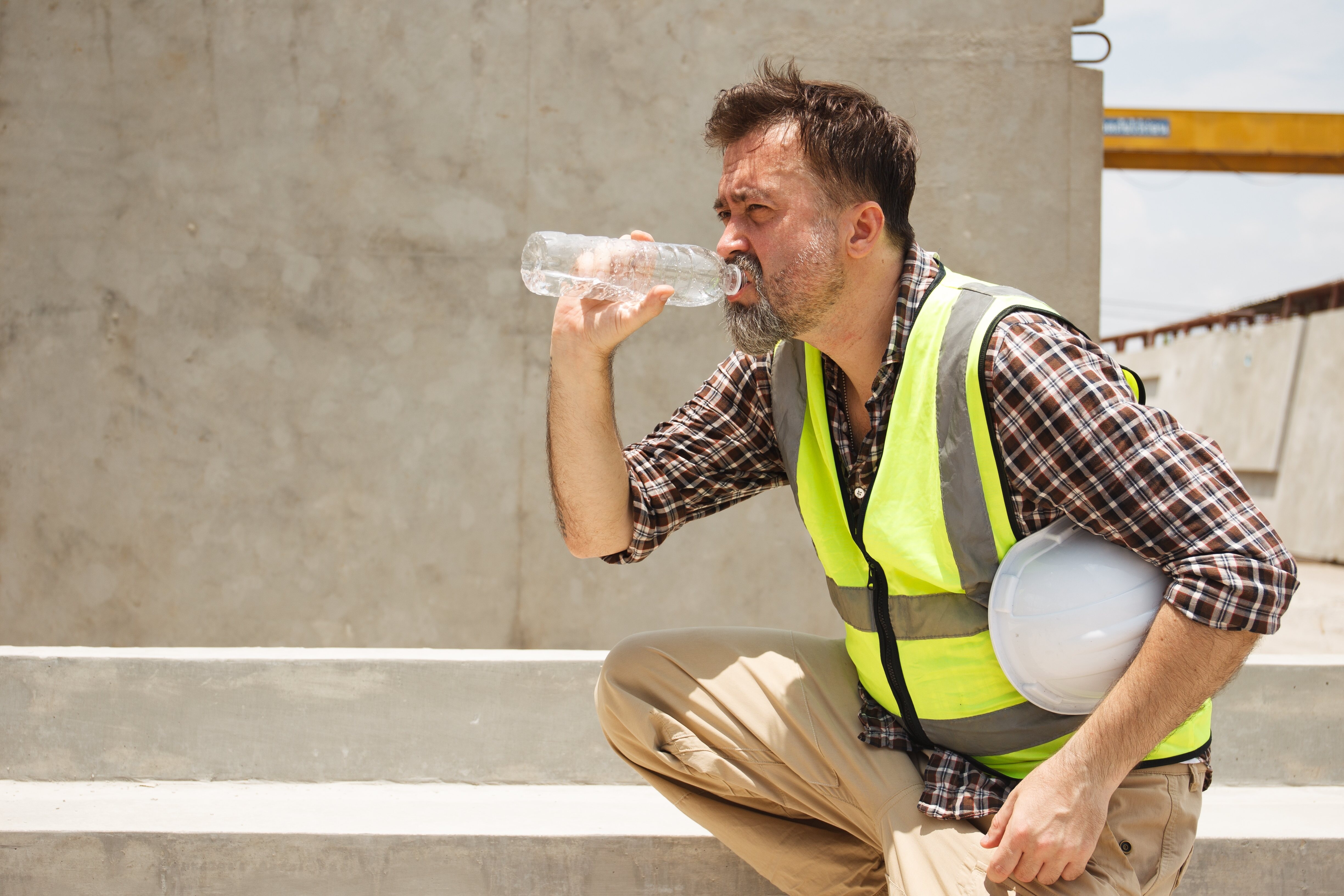 Construction worker drinking water