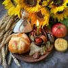 Bread, Candles, Apples, and sunflowers places on a dish 