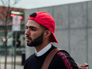 Latino man walking down a street