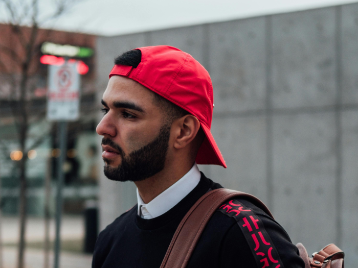 Latino man walking down a street
