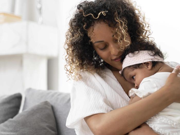 Woman holding a baby girl.