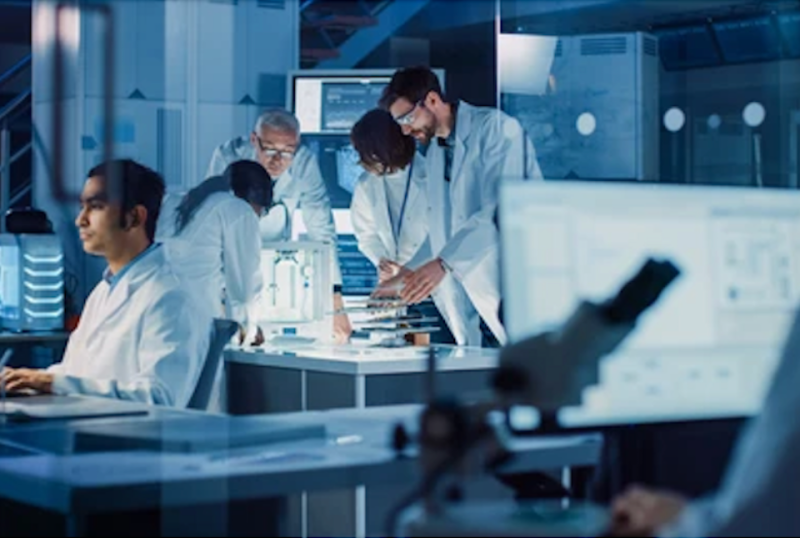 Researchers working with test samples and microscopes