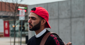 Latino man walking down a street