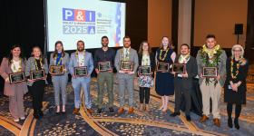 Emerging leaders holding their plaques.